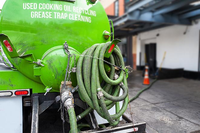 a professional technician pumping a restaurant's grease trap in Chadwicks